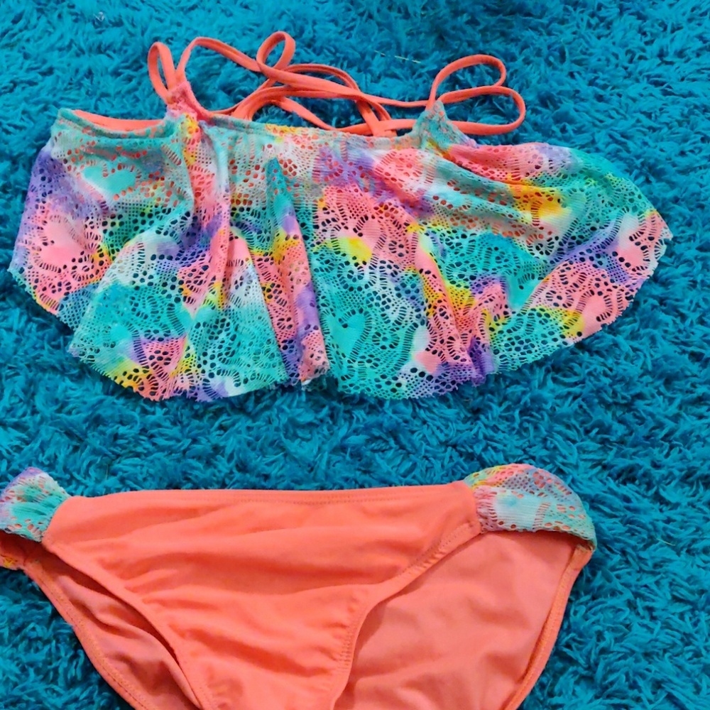 A kid's bathing suit with orange and other colors